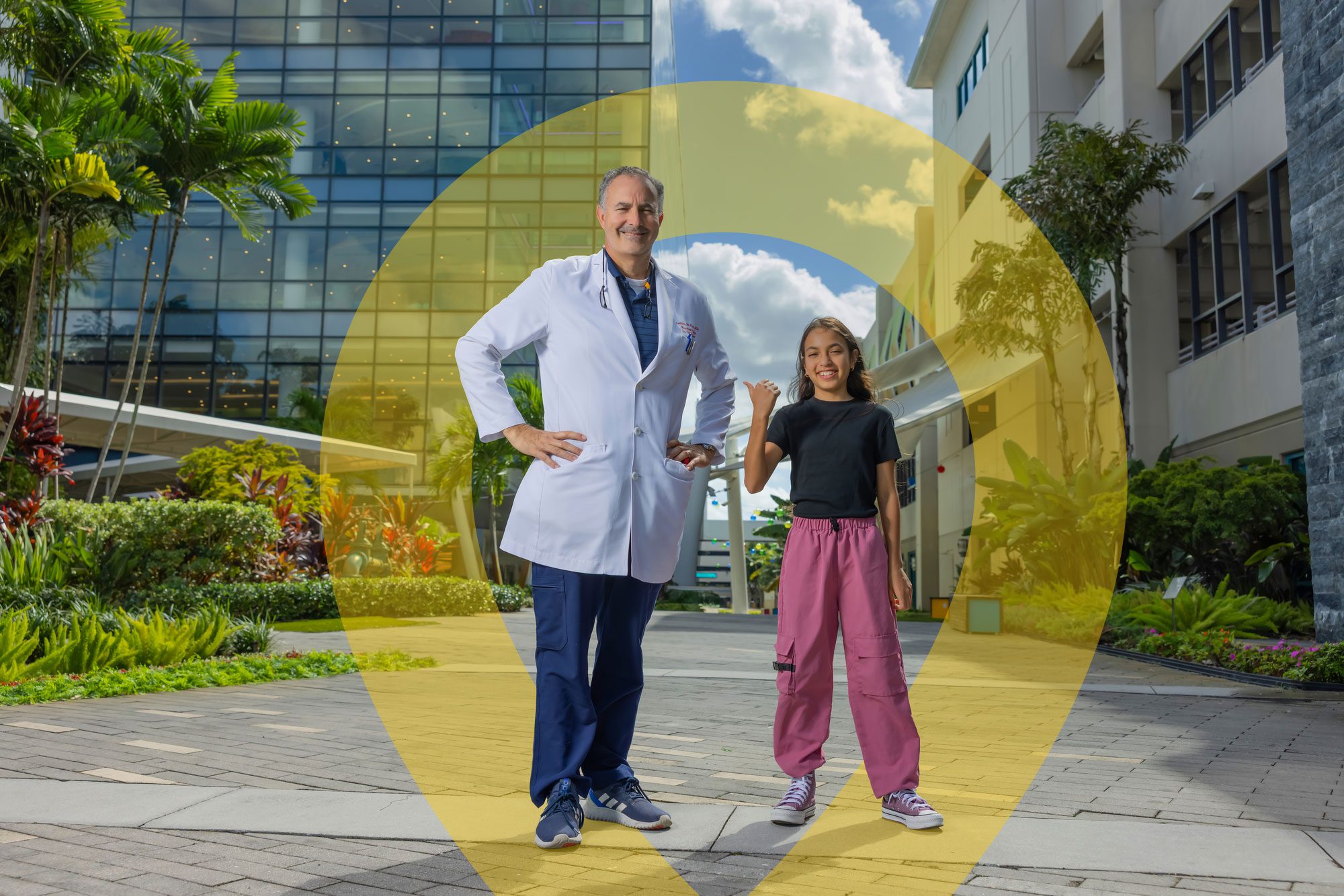 Doctor and child standing outside a children’s hospital.
